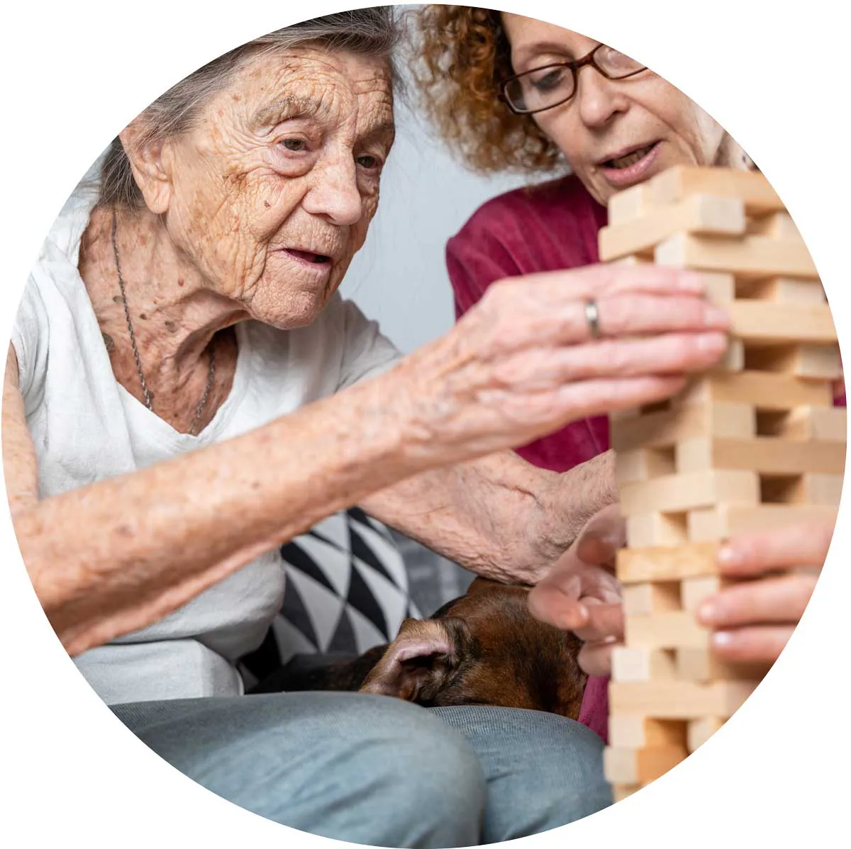 Older woman playing a block-stacking game with a younger woman