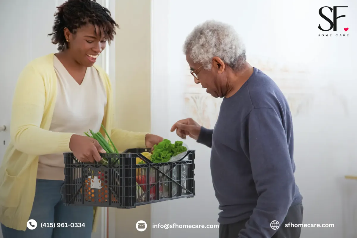 Smiling caregiver assisting an elderly man at home in San Francisco, symbolizing compassionate and reliable home care services.